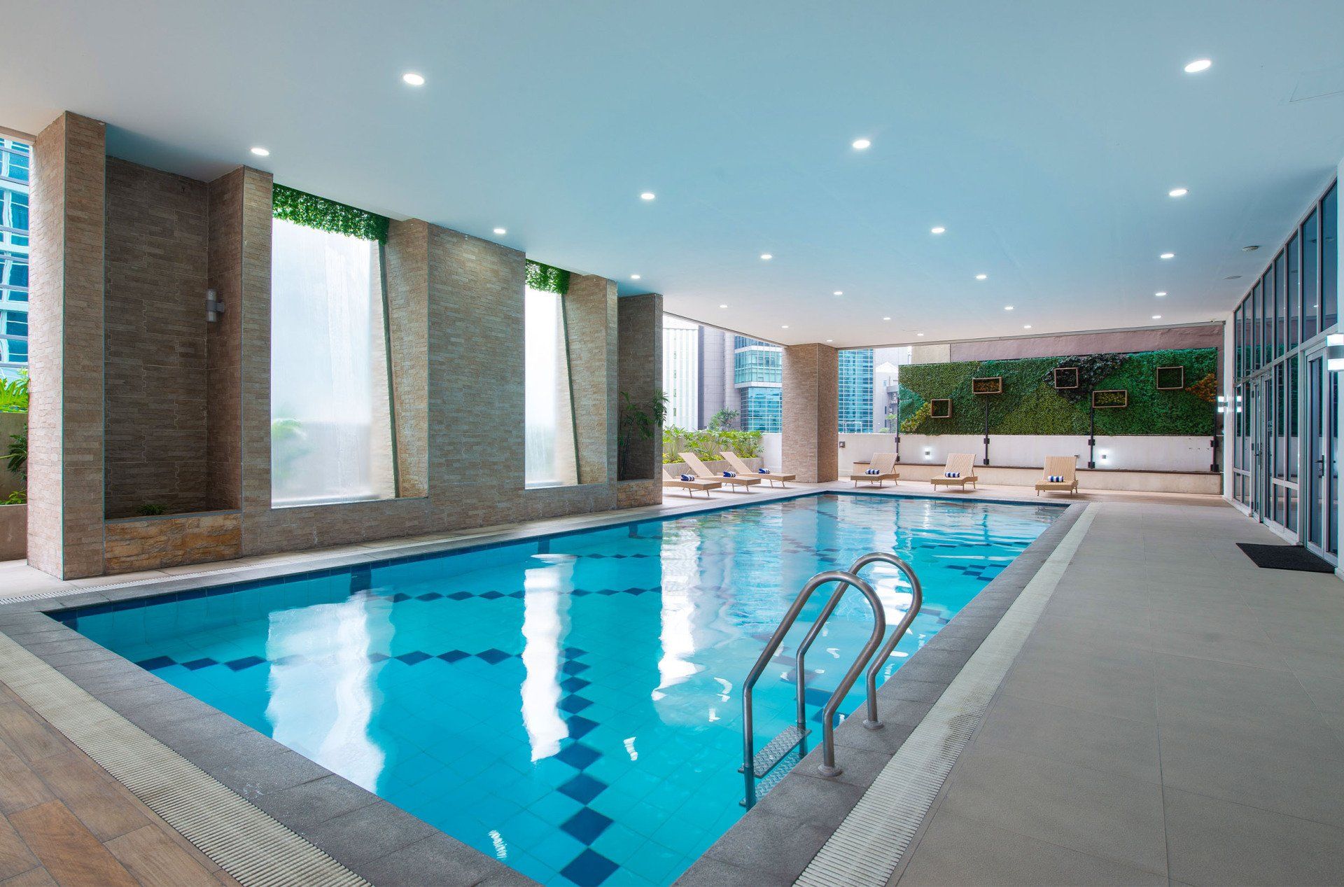 A large indoor swimming pool with stairs leading to it