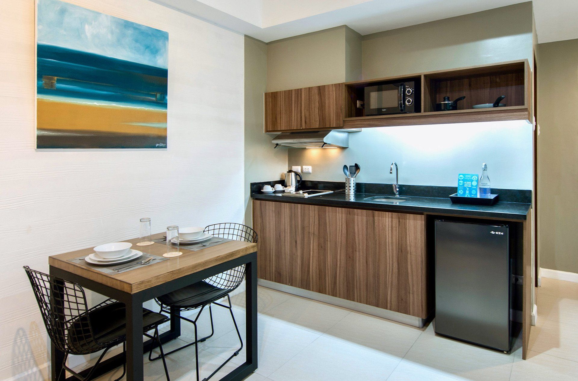 Small kitchen area with a dining table and artwork on the wall.