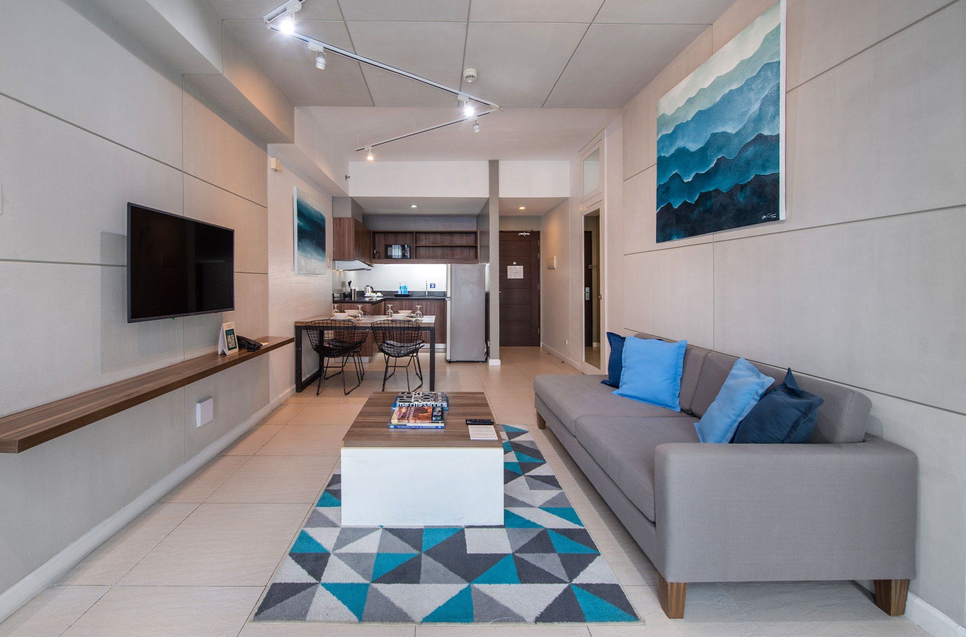 A living room with a couch , coffee table , and television.