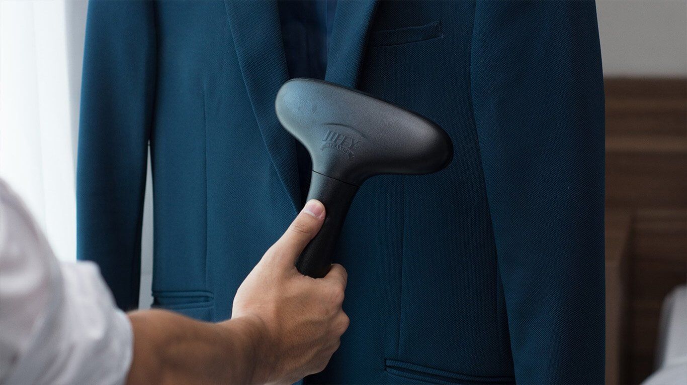 A woman is getting a massage at a spa with candles in the background.