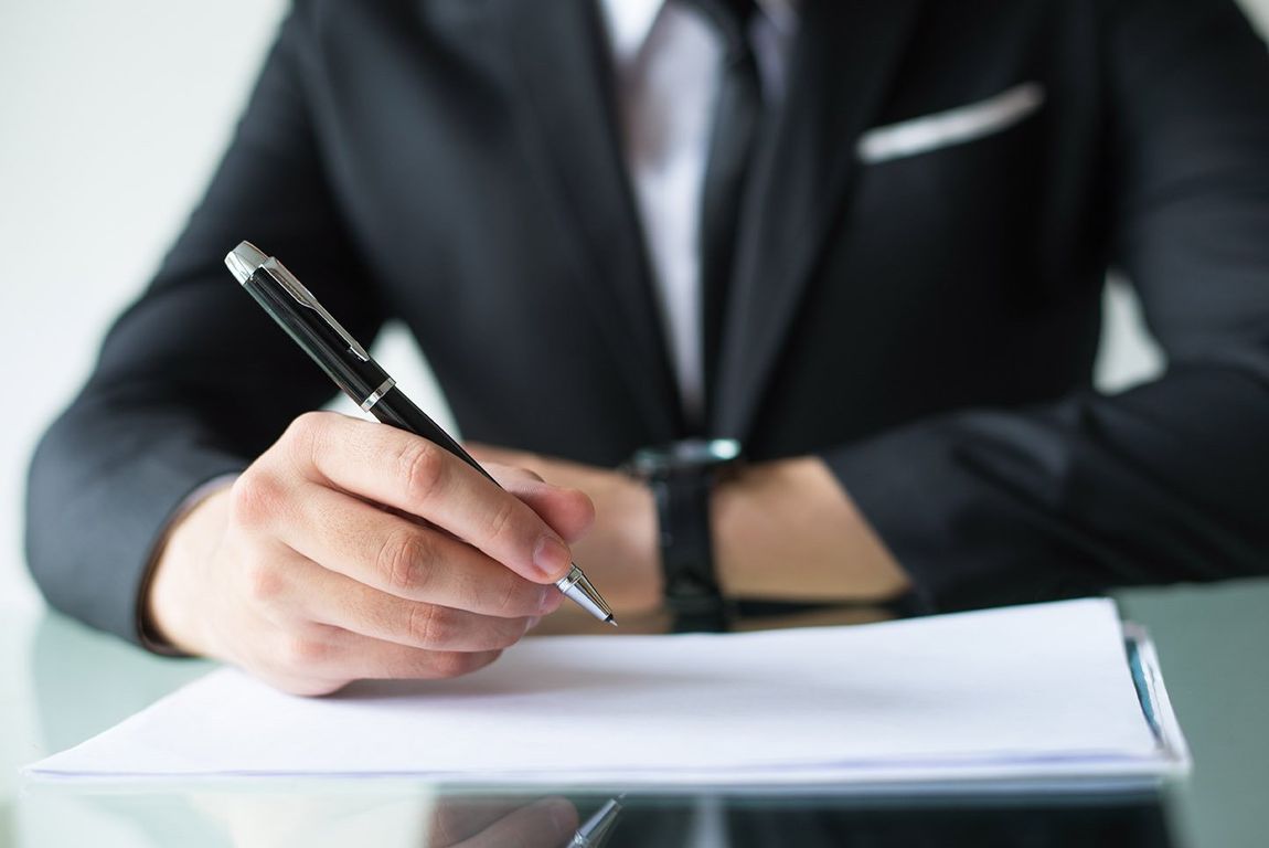 Signing documents at a business event in Makati Hotel
