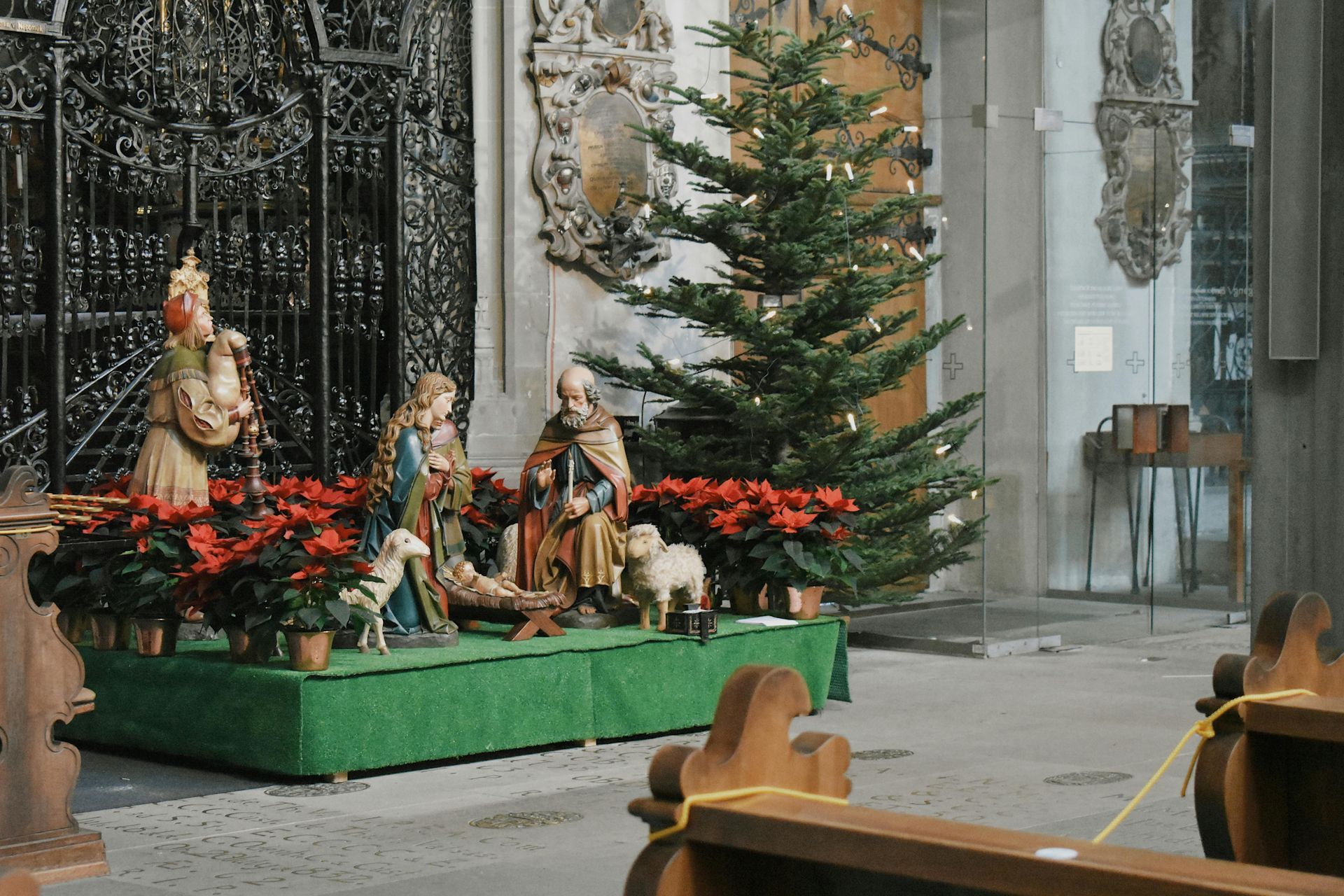 Nativity scene with a Christmas tree inside a church.