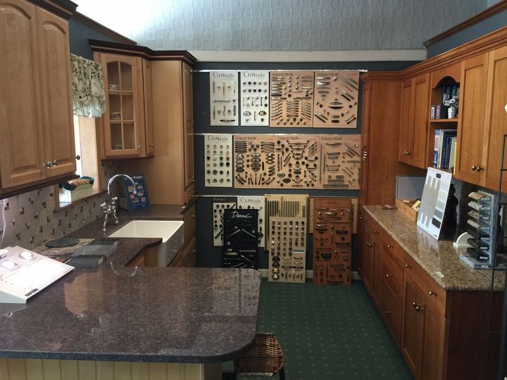 A kitchen with wooden cabinets and granite counter tops