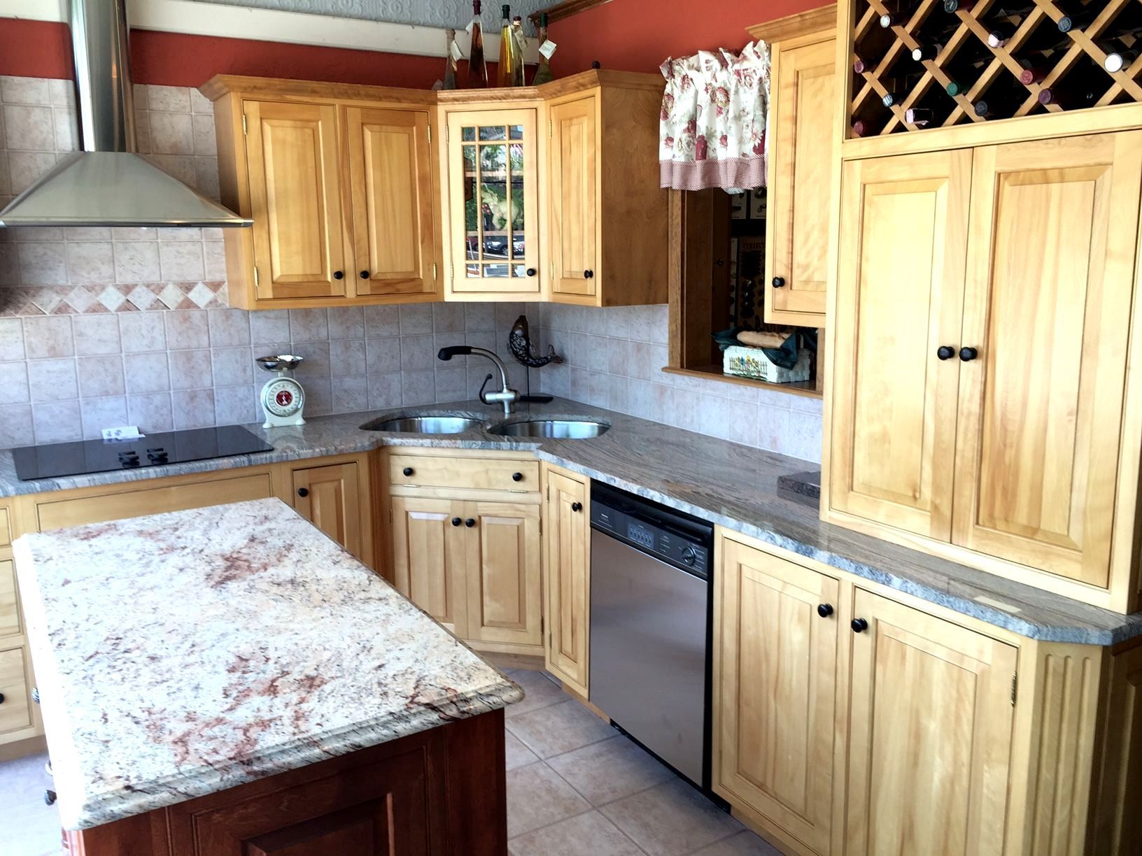A kitchen with wooden cabinets and granite counter tops