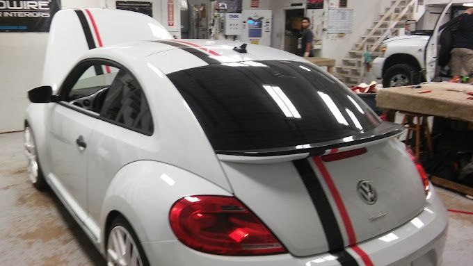 A white car with black and red stripes on it