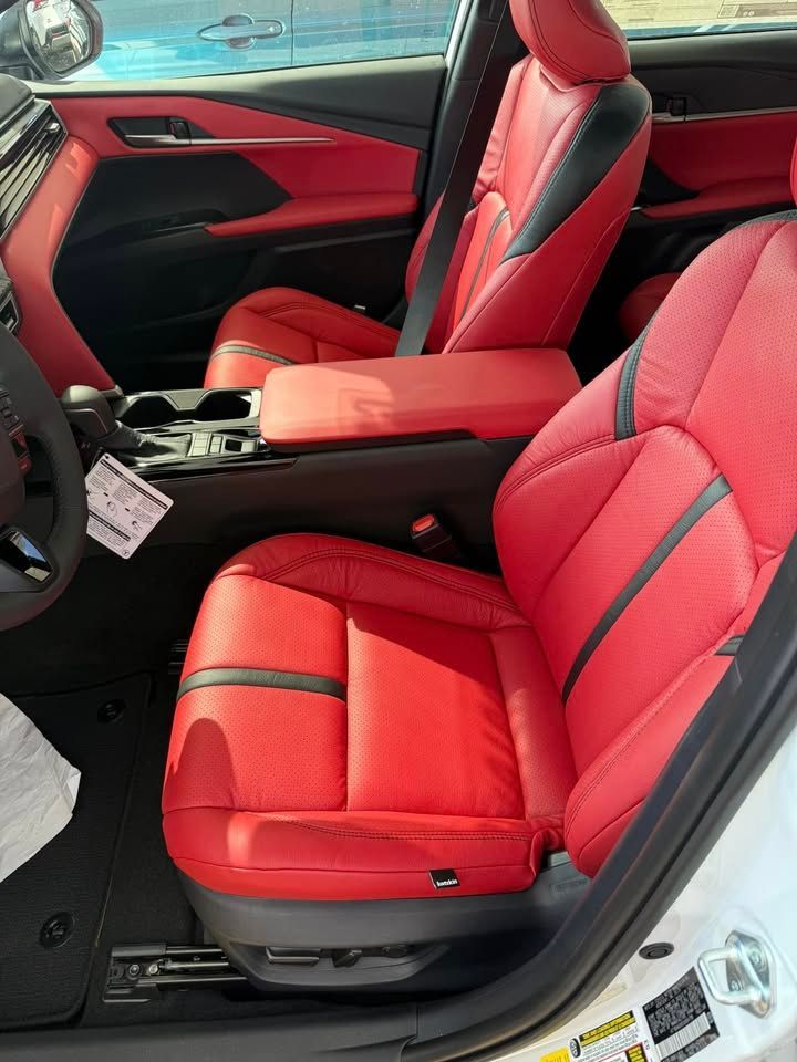 The interior of a white car with red leather seats.