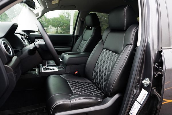 The interior of a toyota tundra with black leather seats