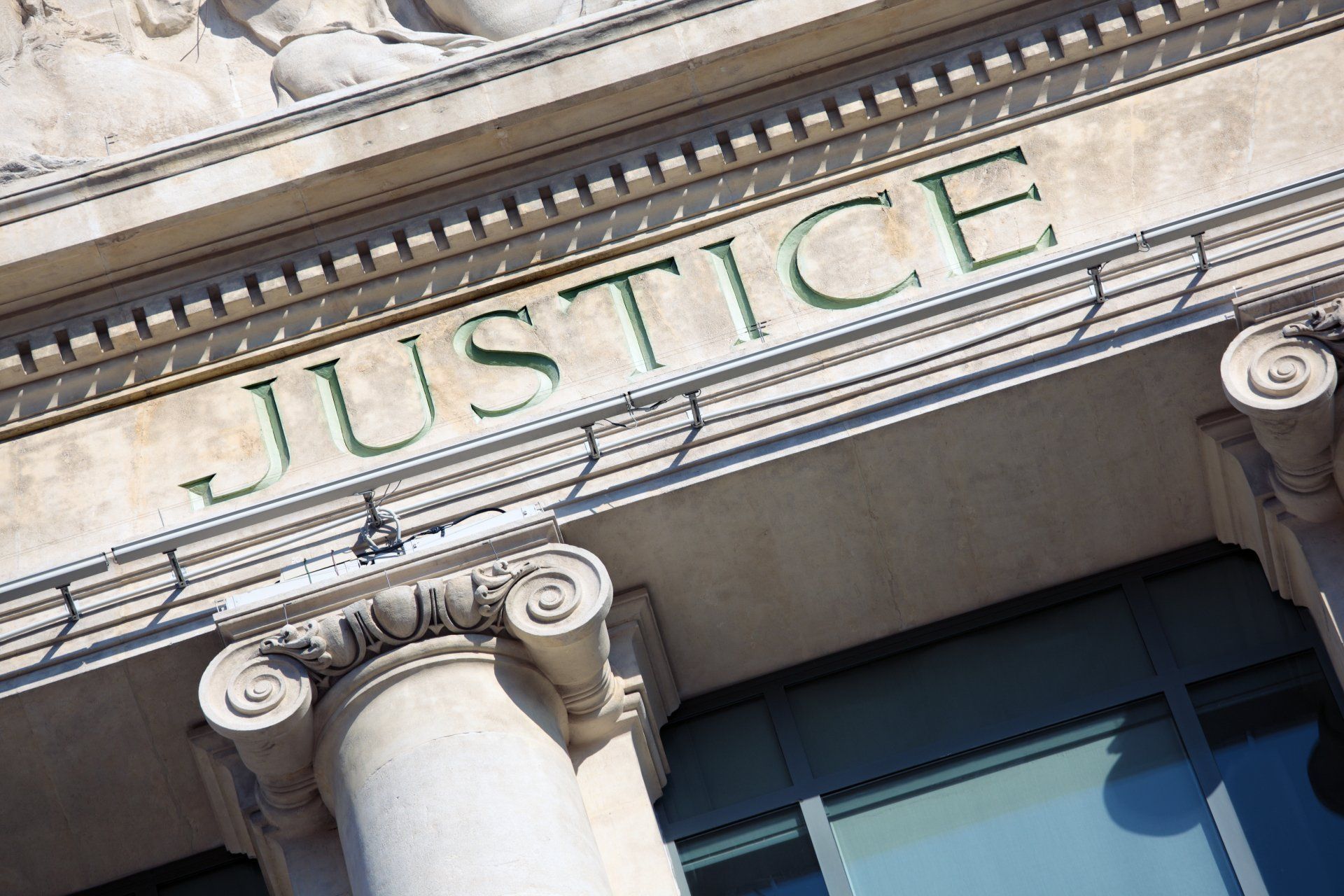 justice written on columns of courthouse