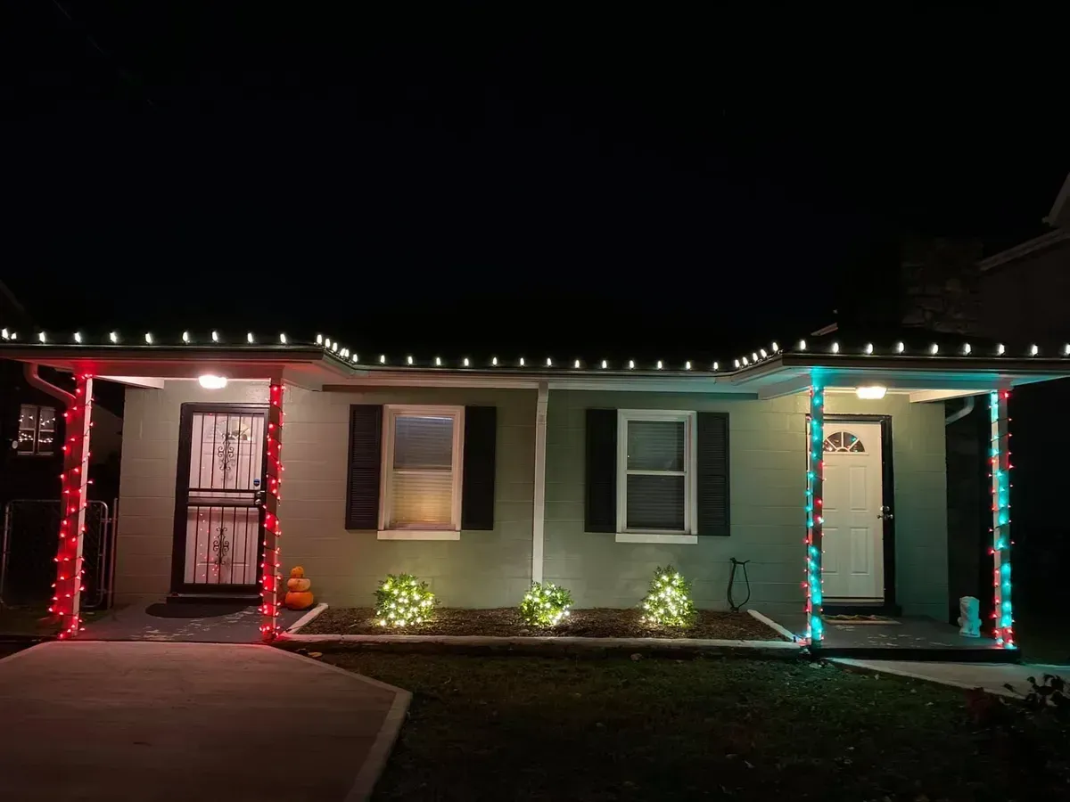 A house is decorated with christmas lights at night.