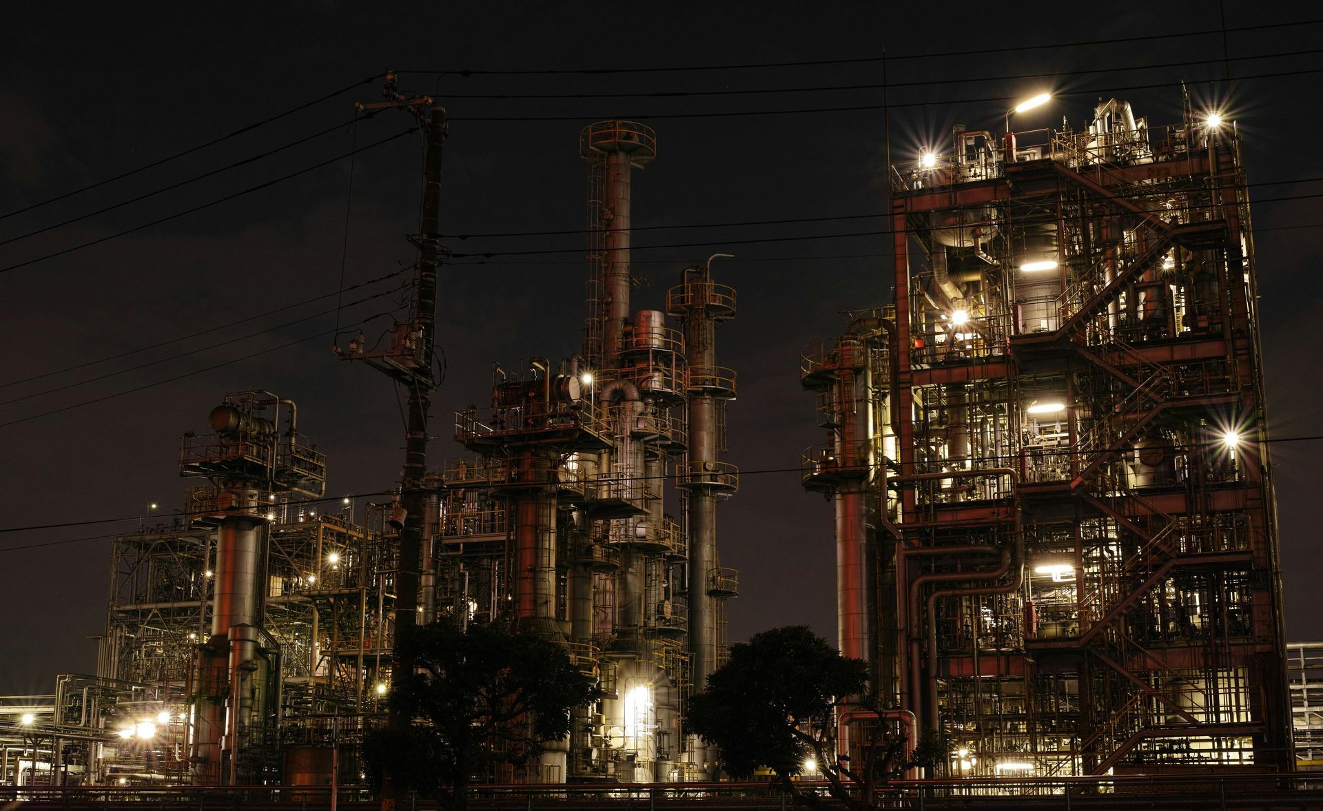A large oil refinery is lit up at night.