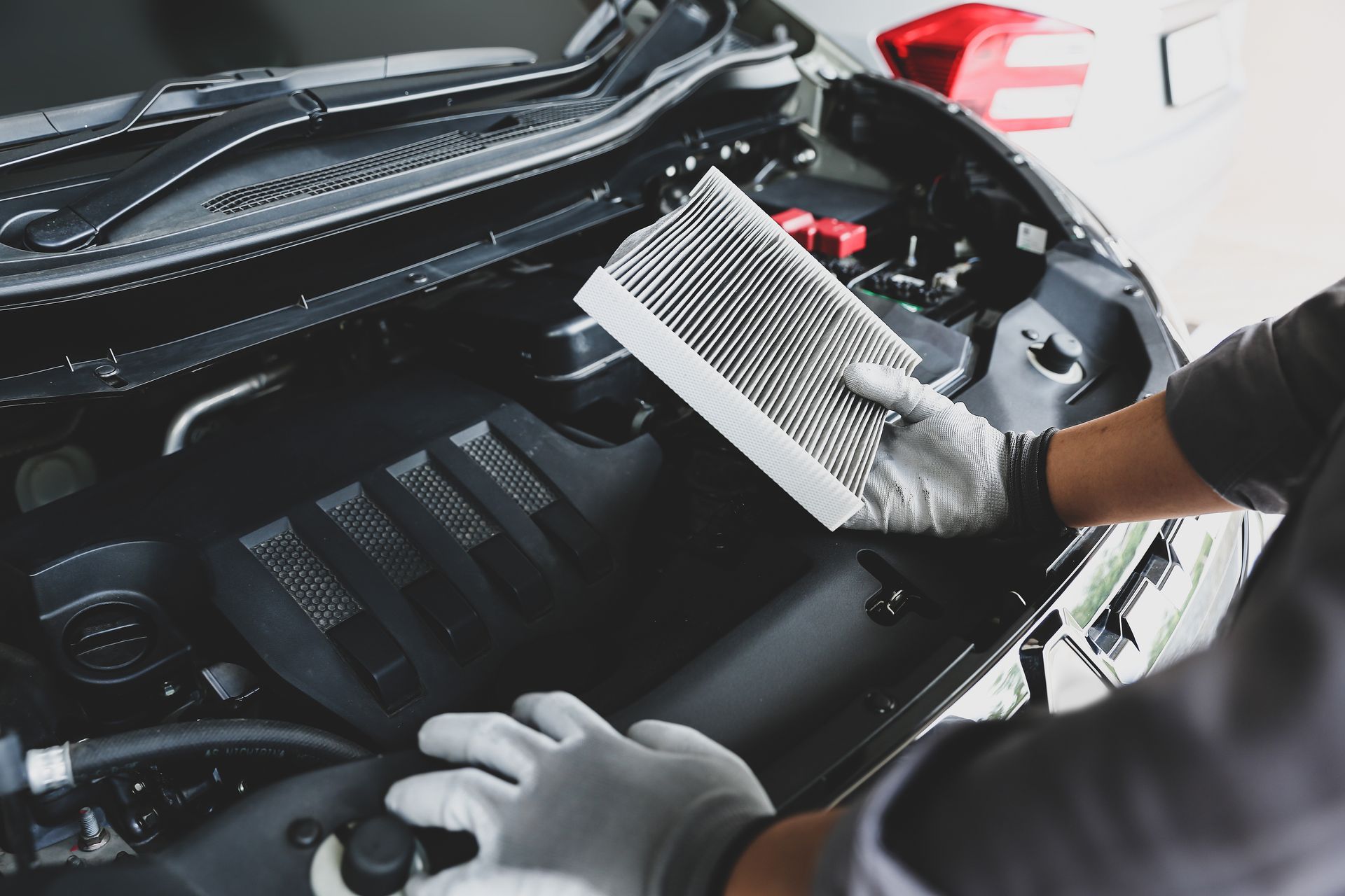 Mechanic replacing the air filter | Two Guyz Automotive