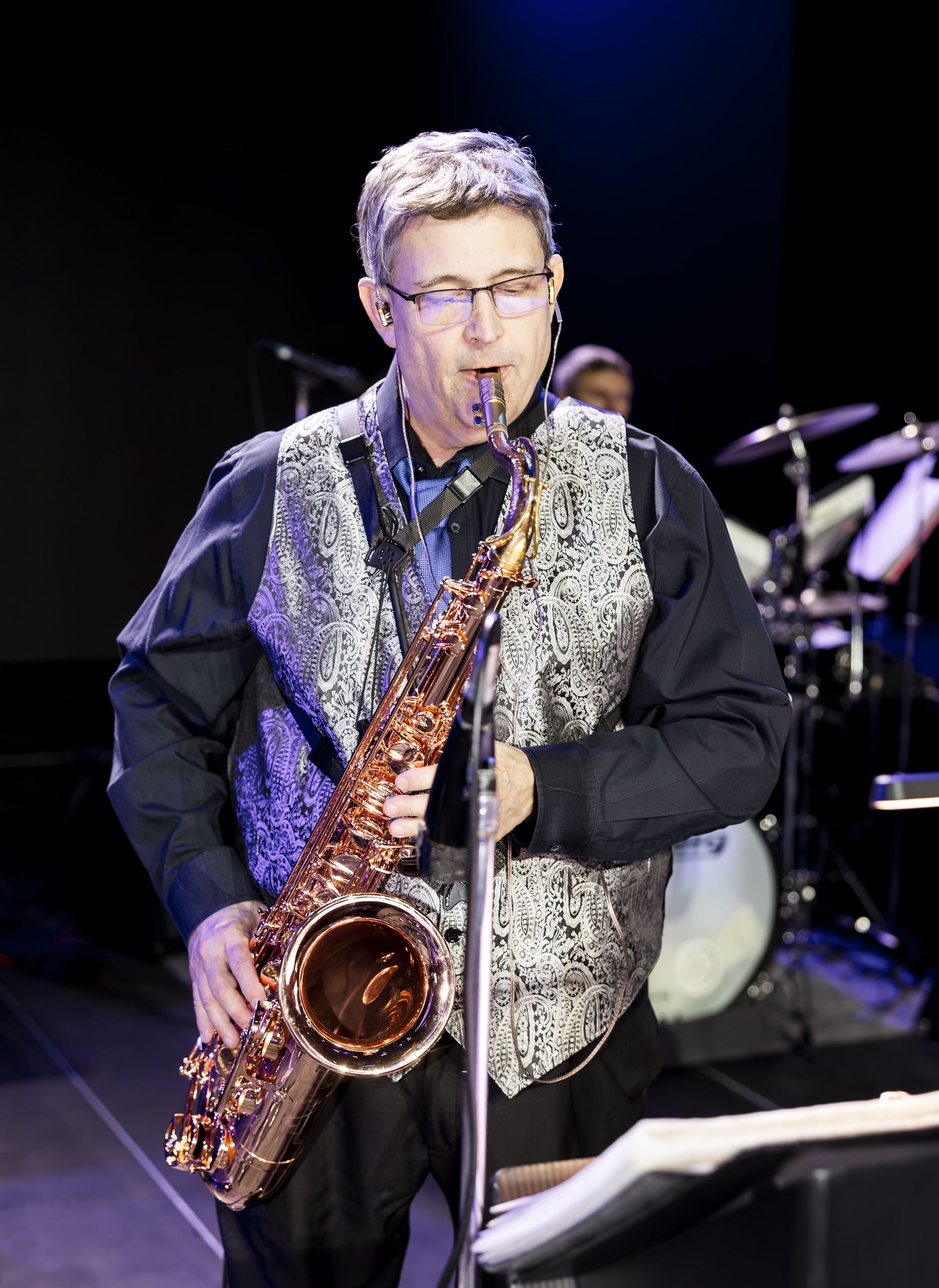 A group of people are playing instruments on a stage.
