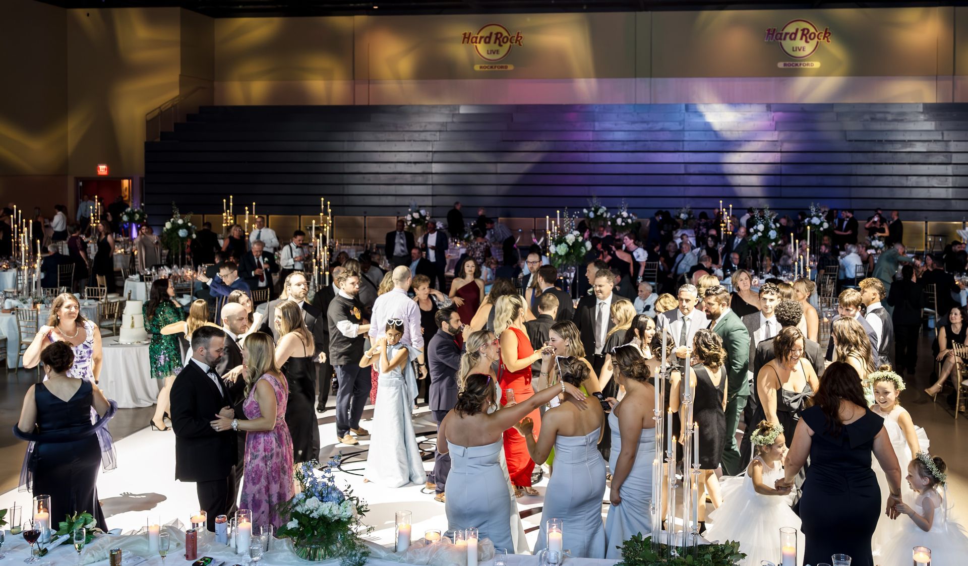 A group of men are playing drums on a stage in front of a crowd.