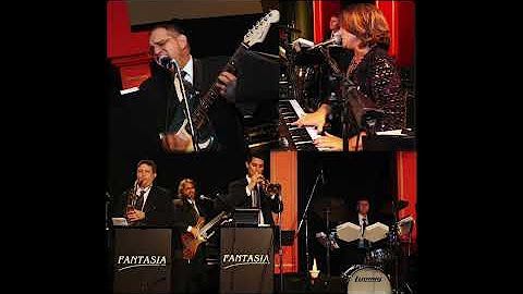 A group of people are playing instruments on a stage.