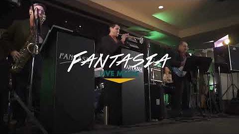 A group of people are playing instruments on a stage.