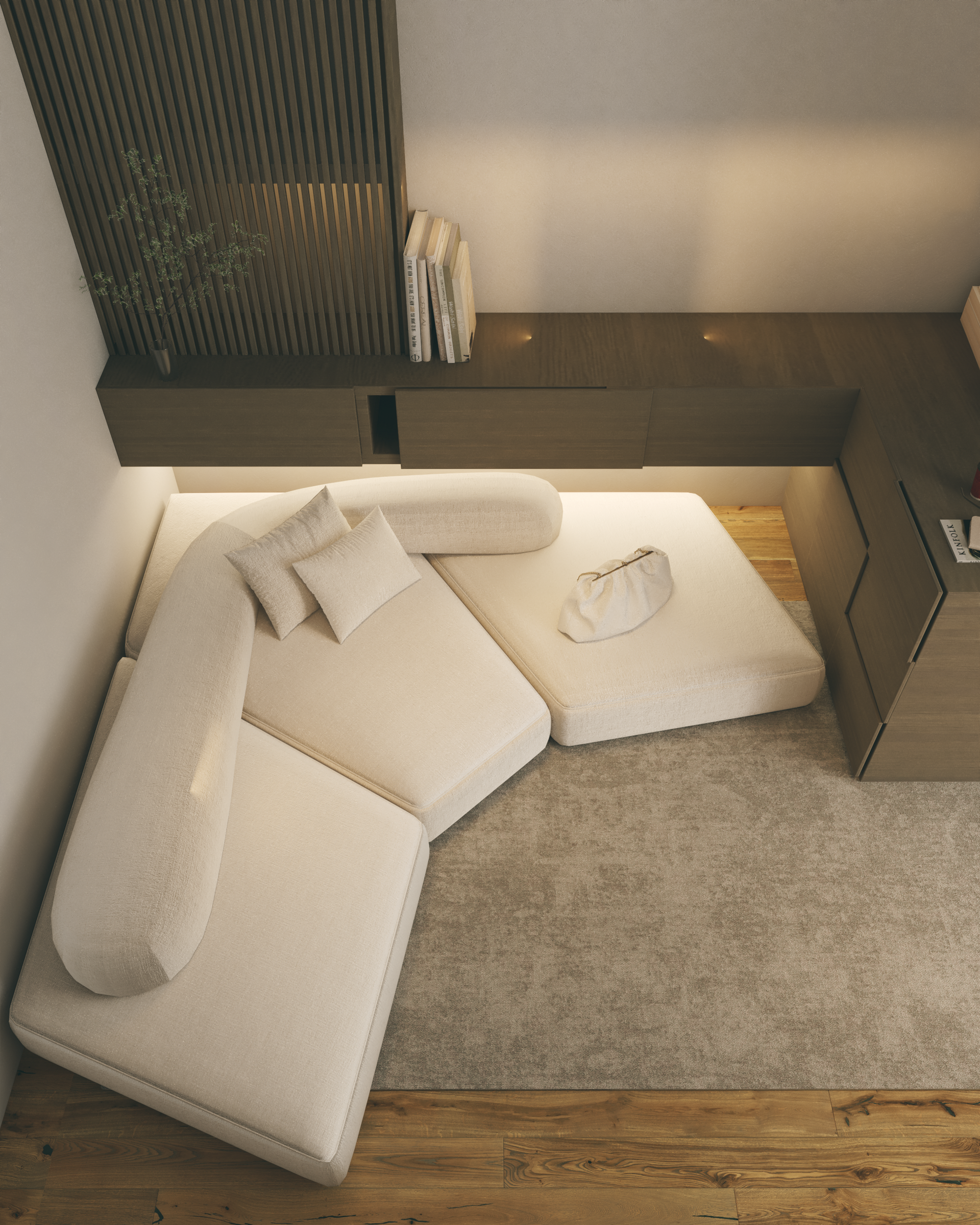 Moderno sofá modular de color crema en una estancia de tonos neutros, junto a una estantería de pared empotrada.