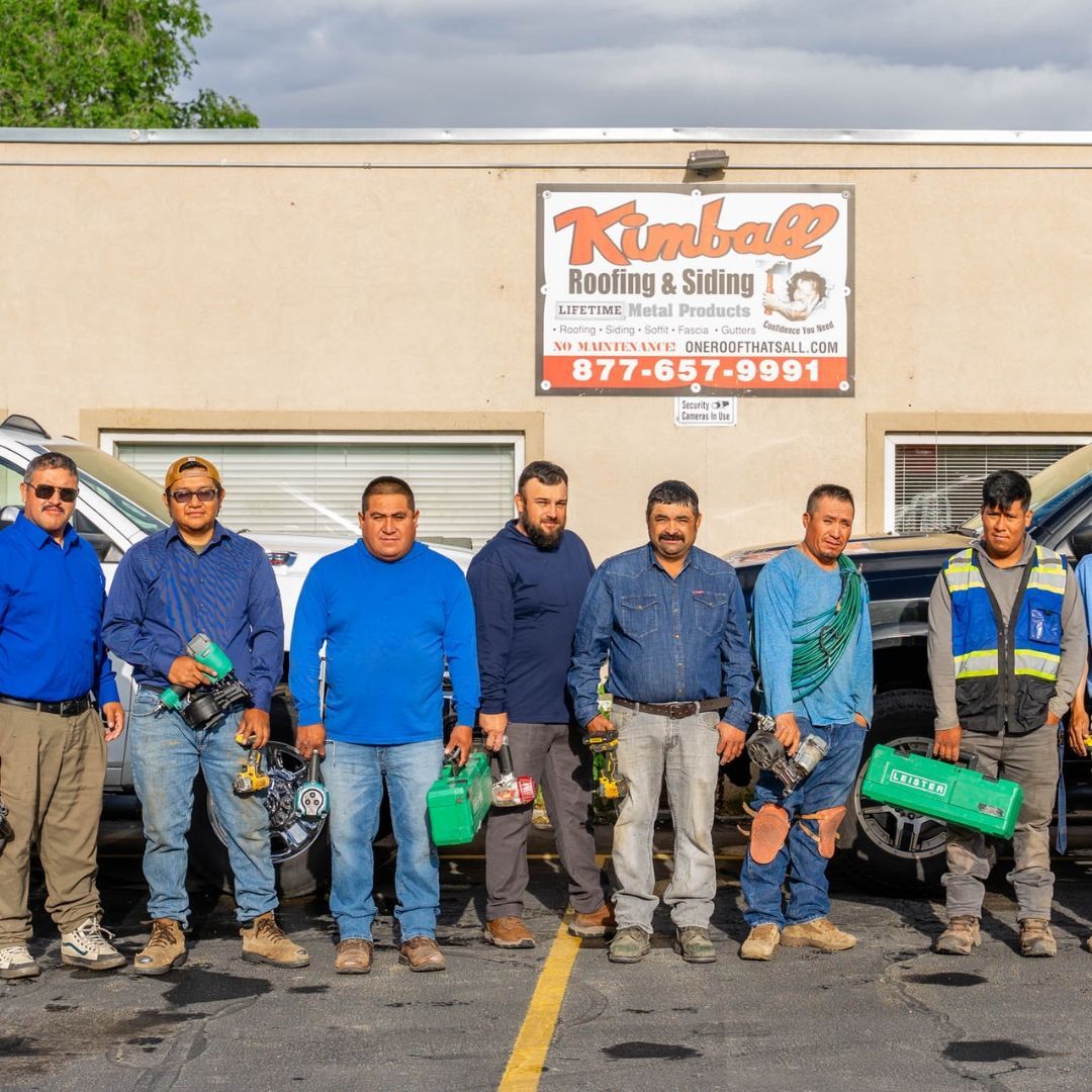 Group of workers in front of a building with tools. 
