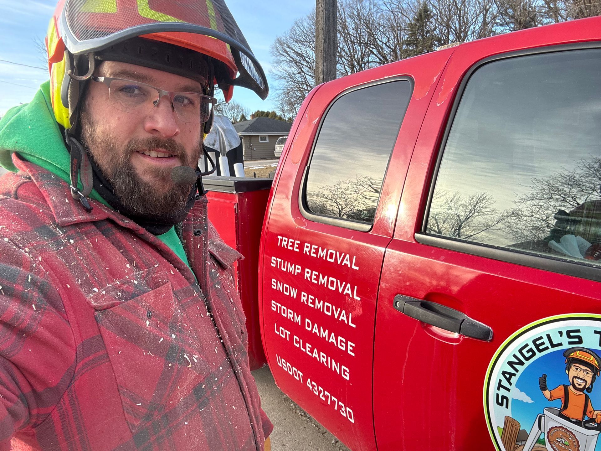 Man in work attire next to a red truck with business logo; services include tree removal and snow removal.