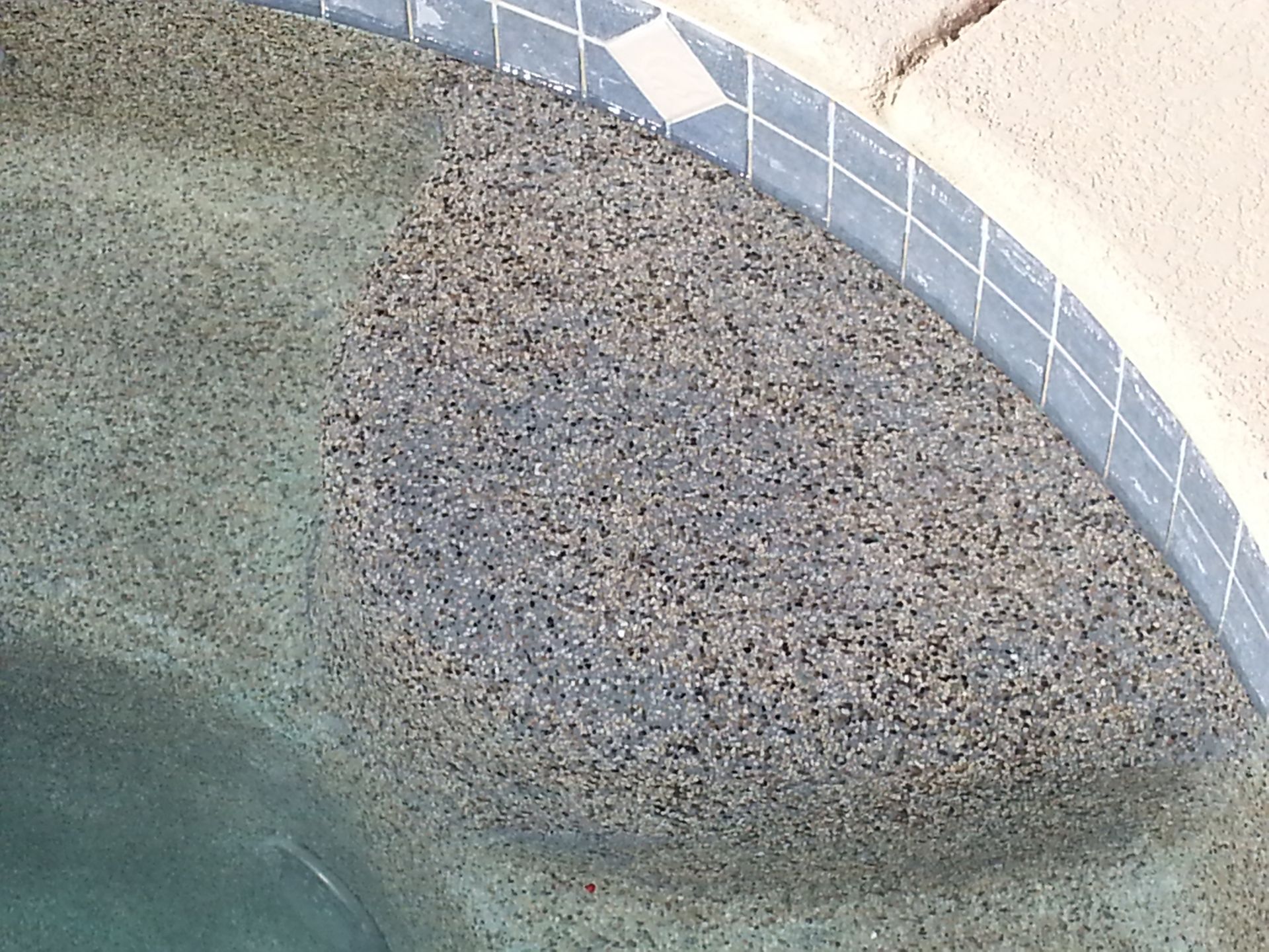 A close up of a swimming pool with a tile border