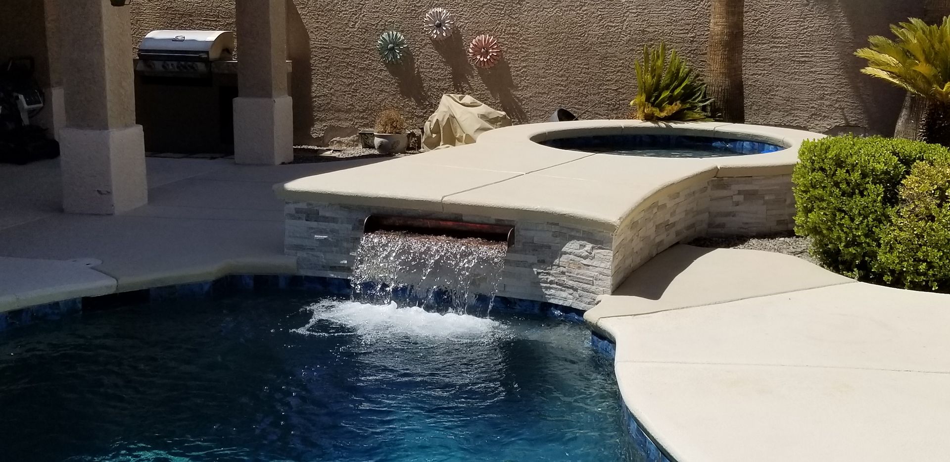 There is a waterfall in the middle of the pool.