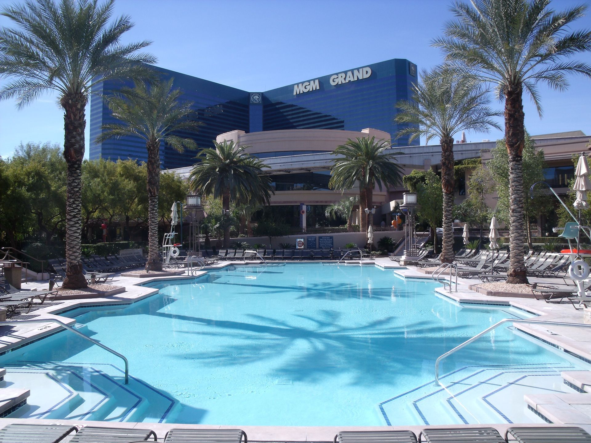 A large swimming pool in front of a hotel called iron grand