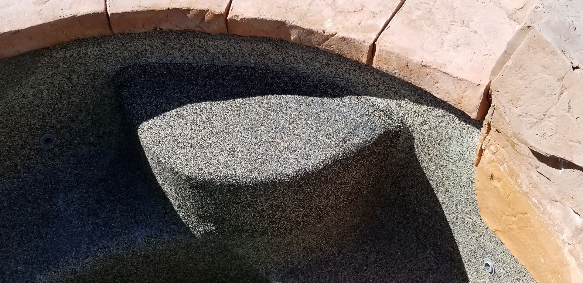 A close up of a rock in the middle of a pool