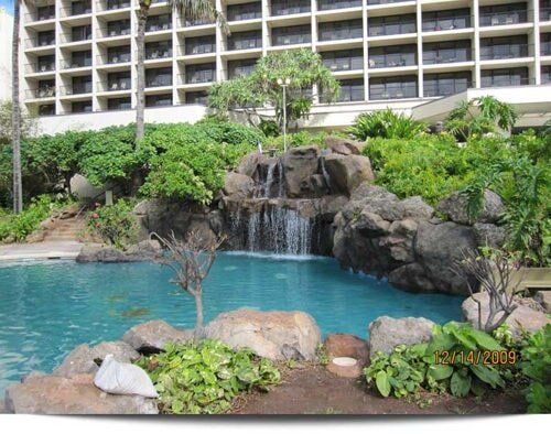 A large building with a waterfall in front of it