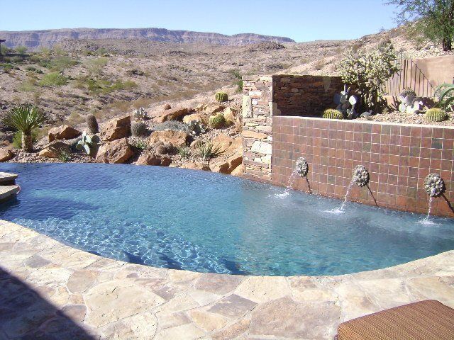 A large swimming pool with a view of the desert