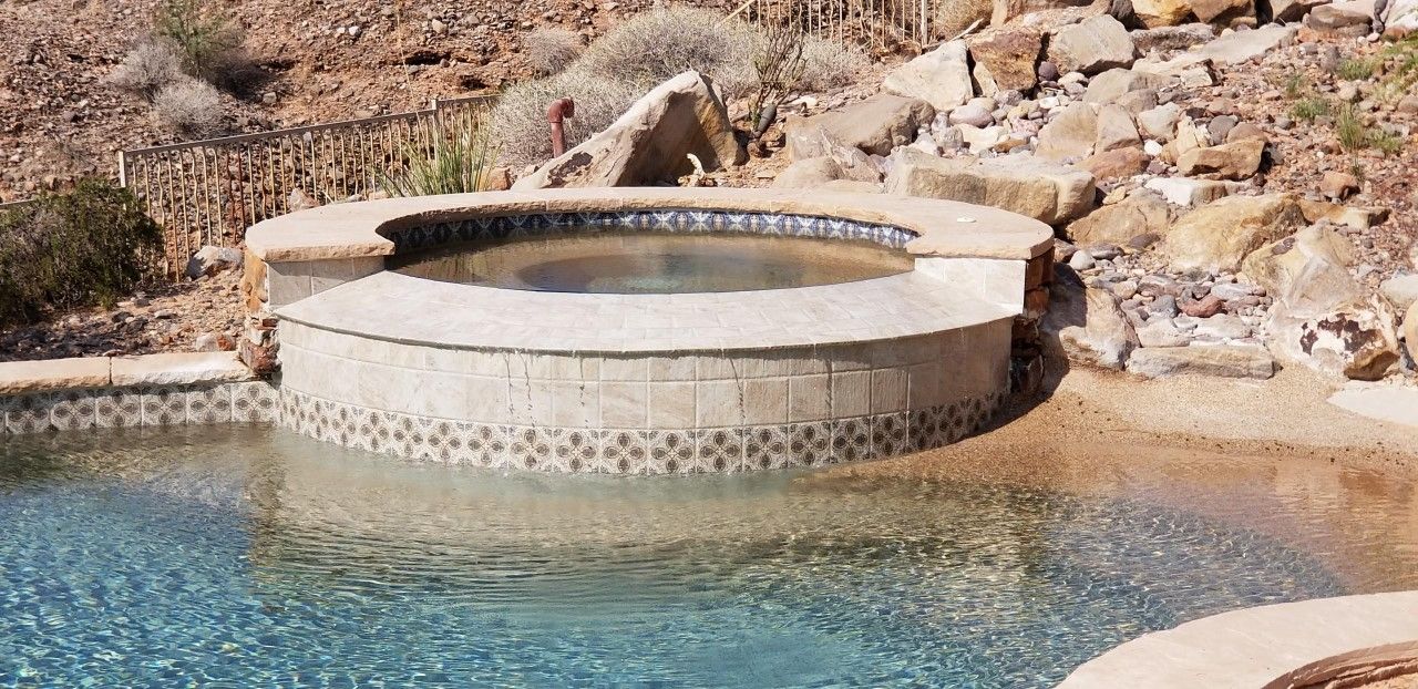 There is a hot tub in the middle of a swimming pool.