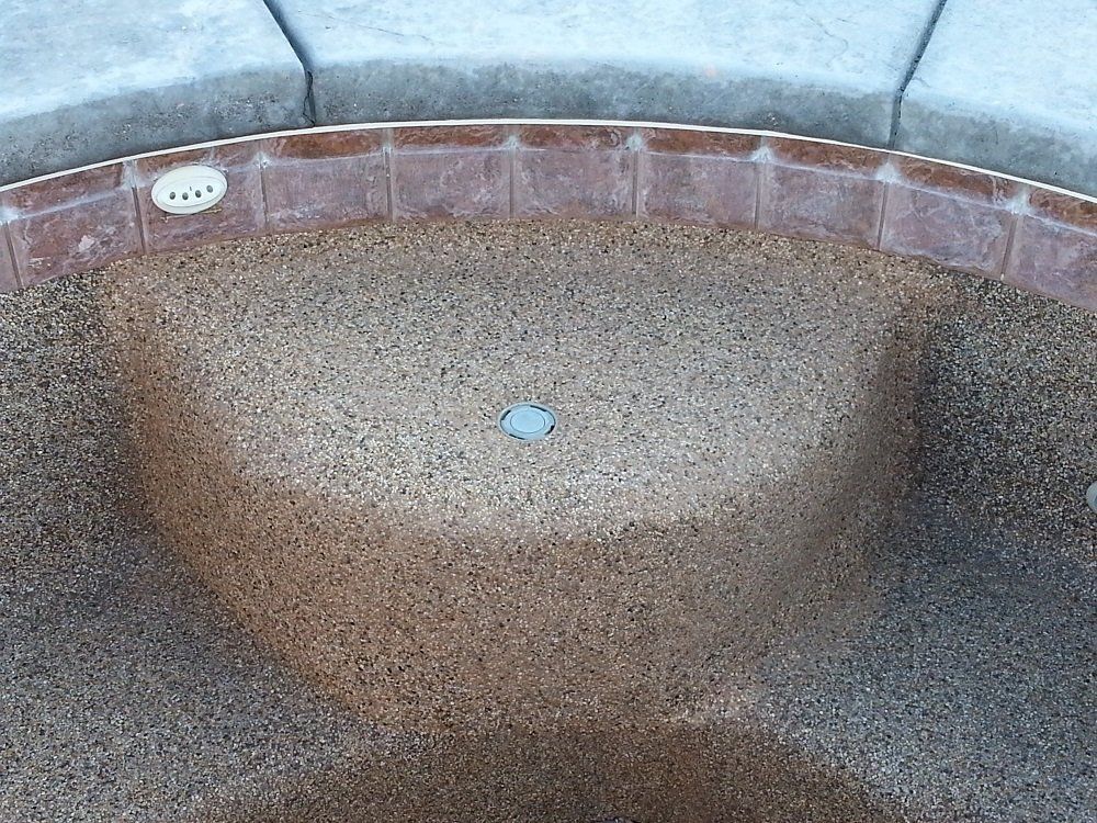 A close up of a hot tub with a drain hole in the middle.