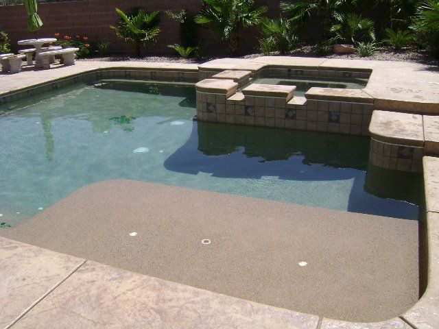 A large swimming pool with steps leading up to it