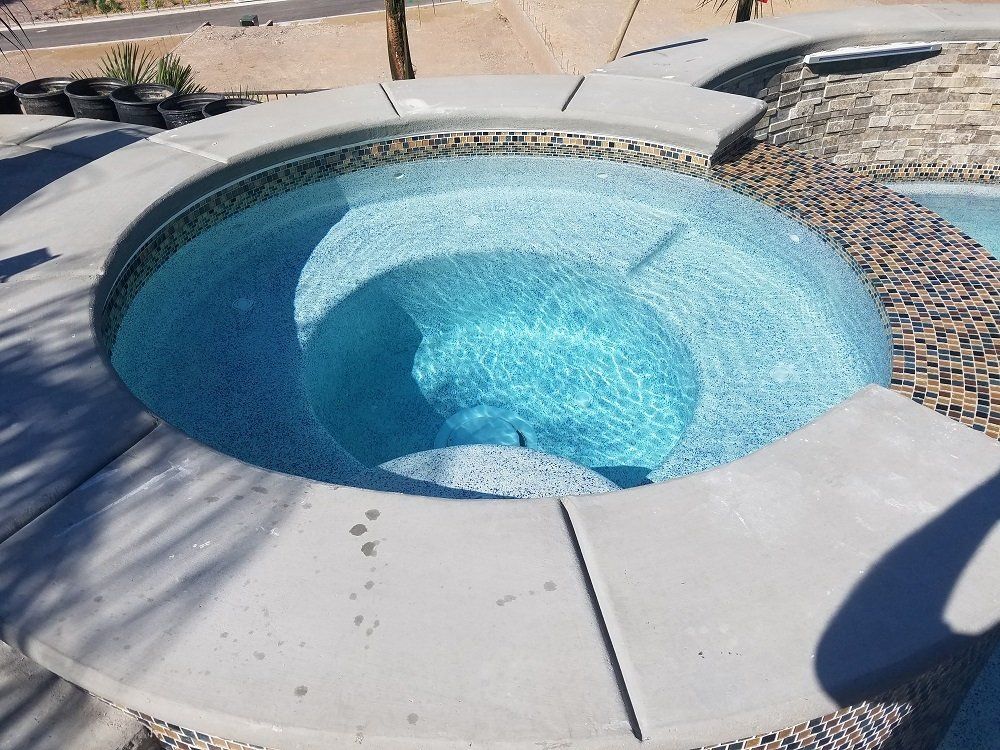 A hot tub in the middle of a swimming pool