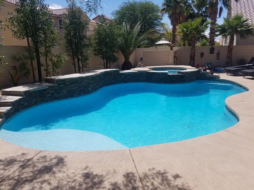 A large swimming pool with palm trees in the background