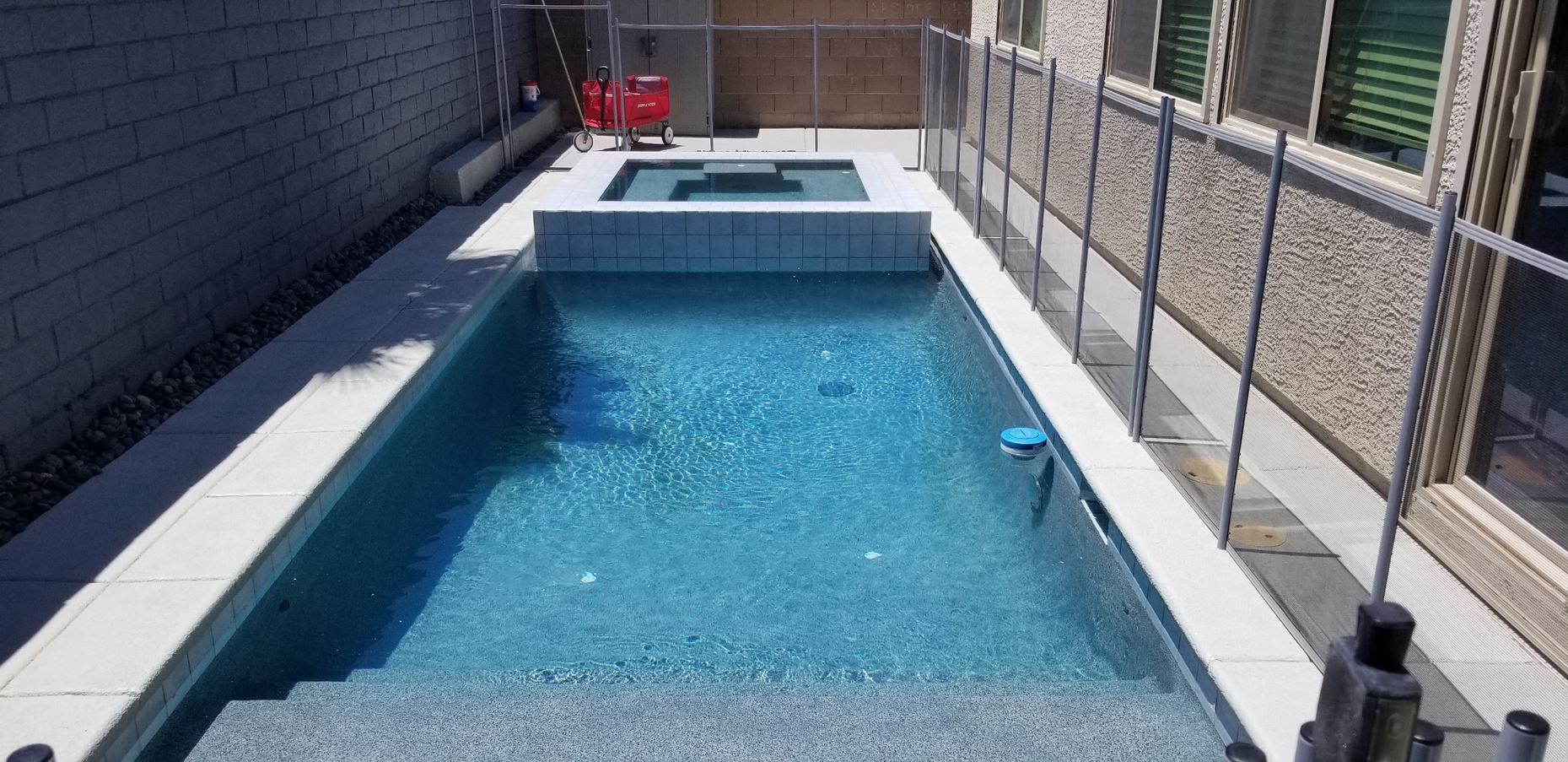 A swimming pool with stairs leading up to it