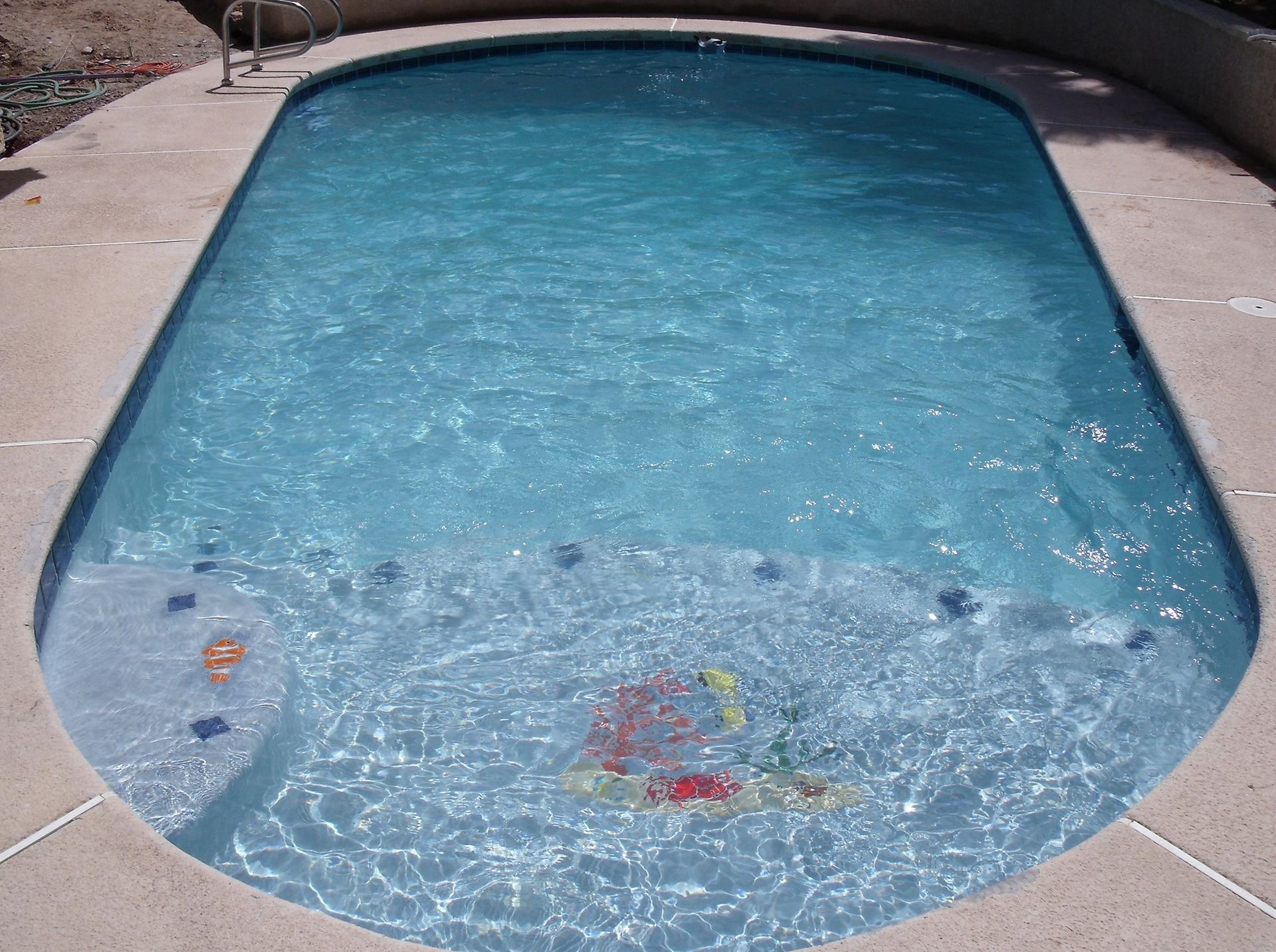 A person is swimming in a large swimming pool