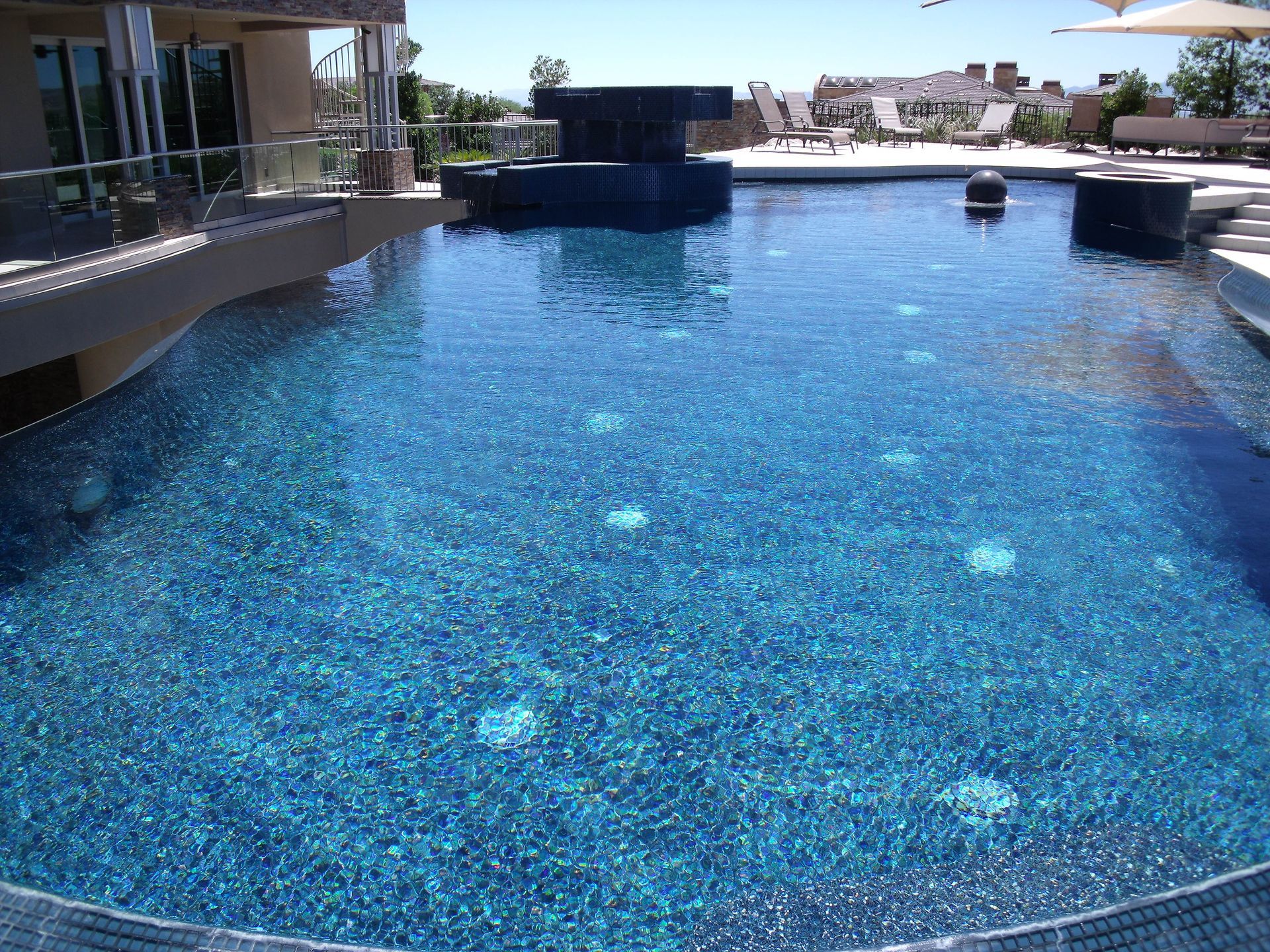 A large swimming pool with a bar in the middle