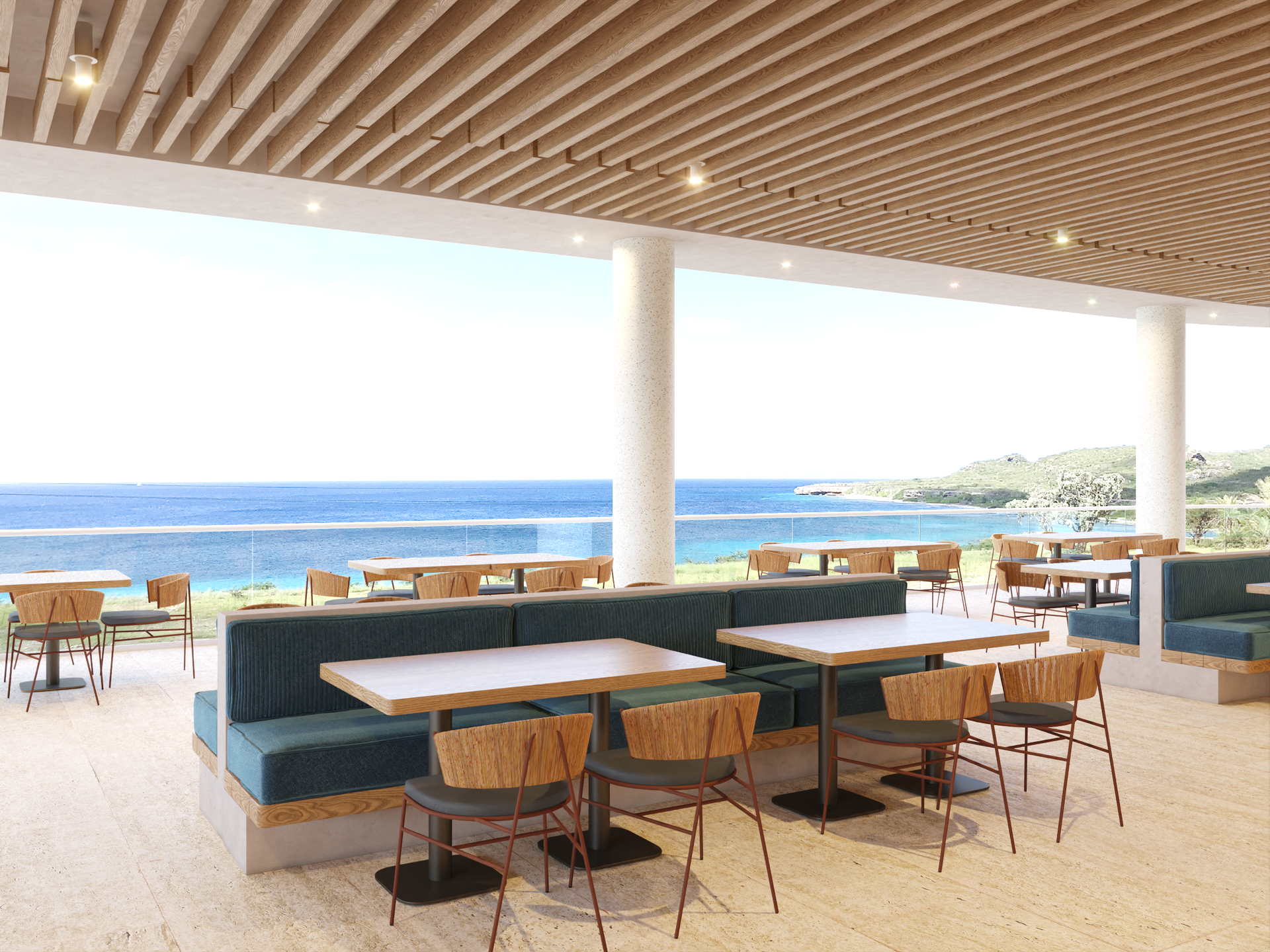 Outdoor restaurant with teal booths and ocean view.