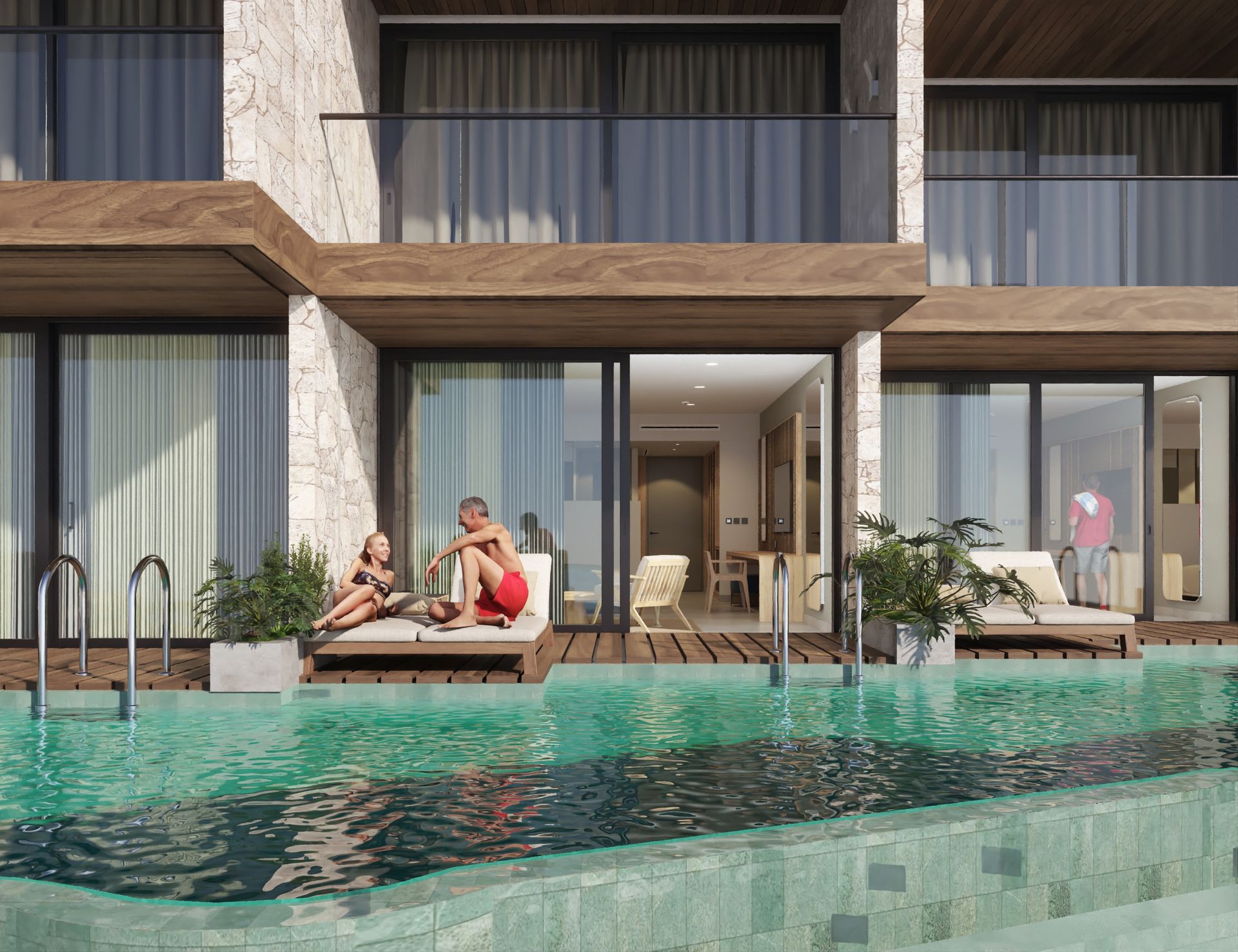 Lounge chairs beside a pool, facing hotel building with palm trees. Sunny day.