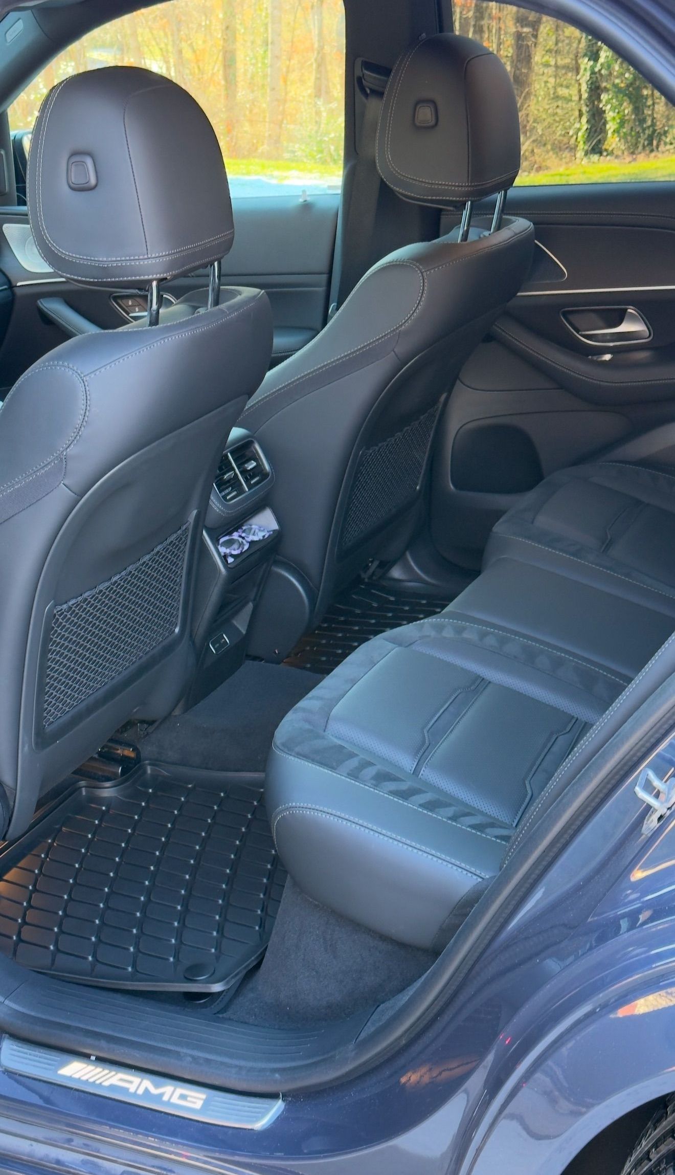 The back seat of a blue mercedes benz s class is shown.