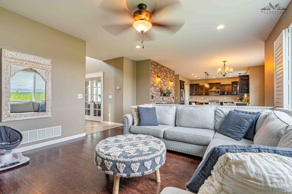 A living room filled with furniture and a ceiling fan.