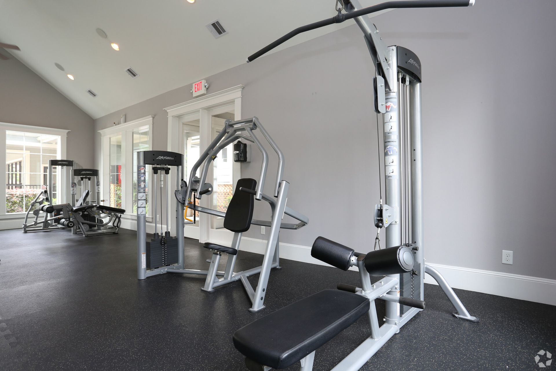 A gym with a lot of exercise equipment in it