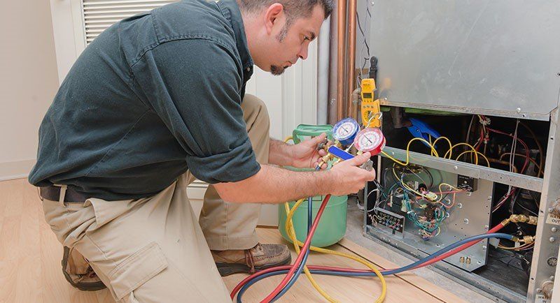 Man Checking the Air Conditioner — Manheim, PA — Garden Spot Mechanical, Inc.