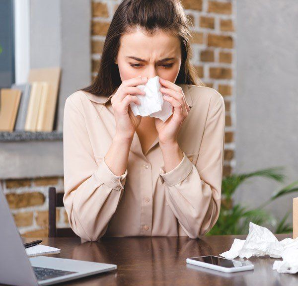 Woman Sneezing on Tissue — Manheim, PA — Garden Spot Mechanical, Inc.