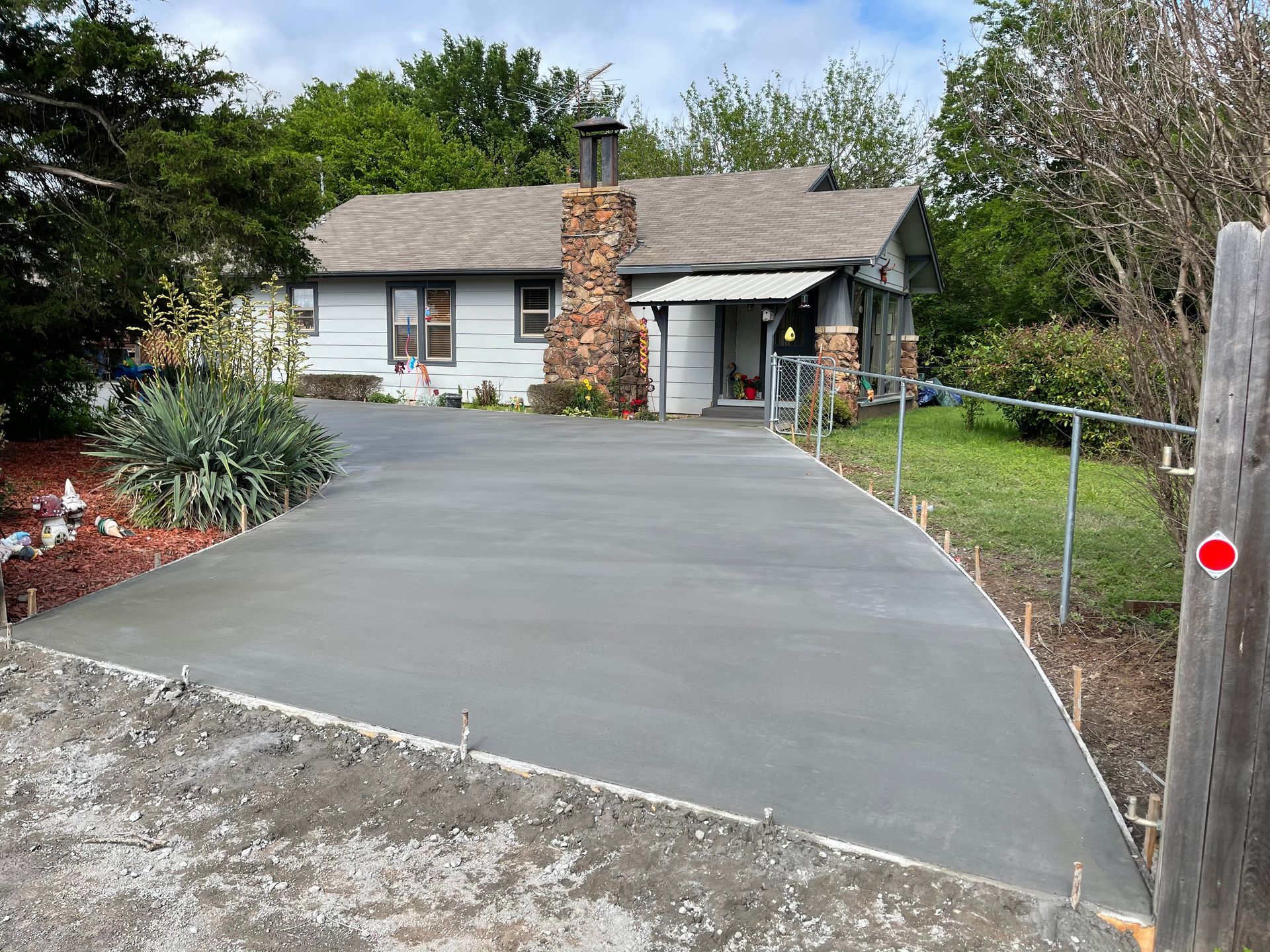 Empty parking garage with pink support columns, yellow speed bumps, and overhead lighting.