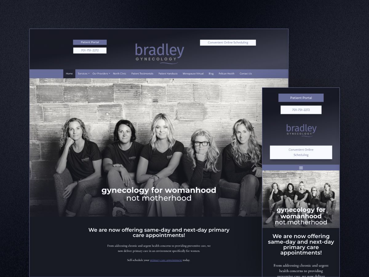A group of women are sitting in front of a brick wall.