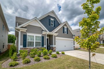 A large house with a blue siding and white trim