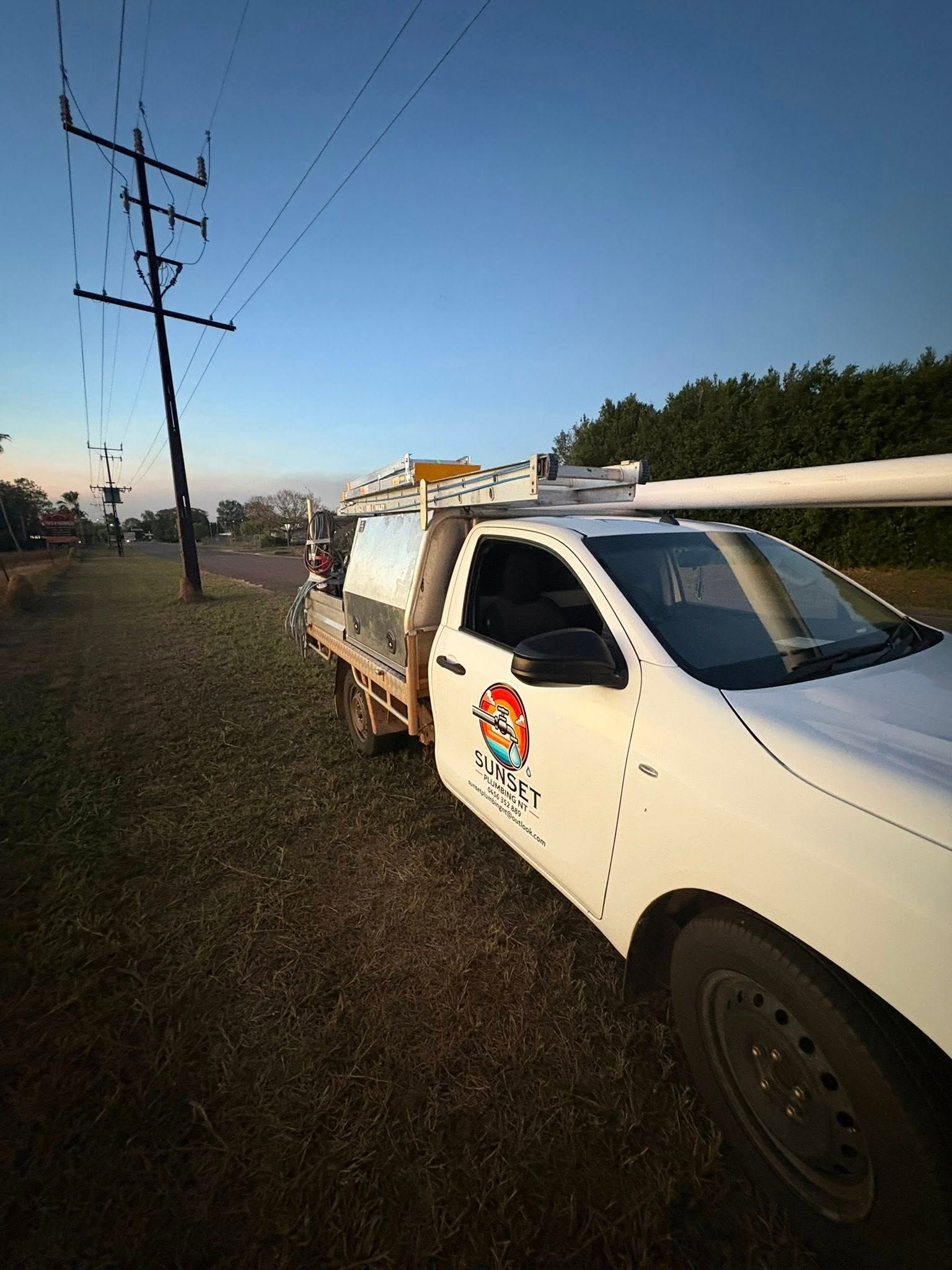 White Utility Truck Parked Near Power Lines — Sunset Plumbing NT in Moil, NT