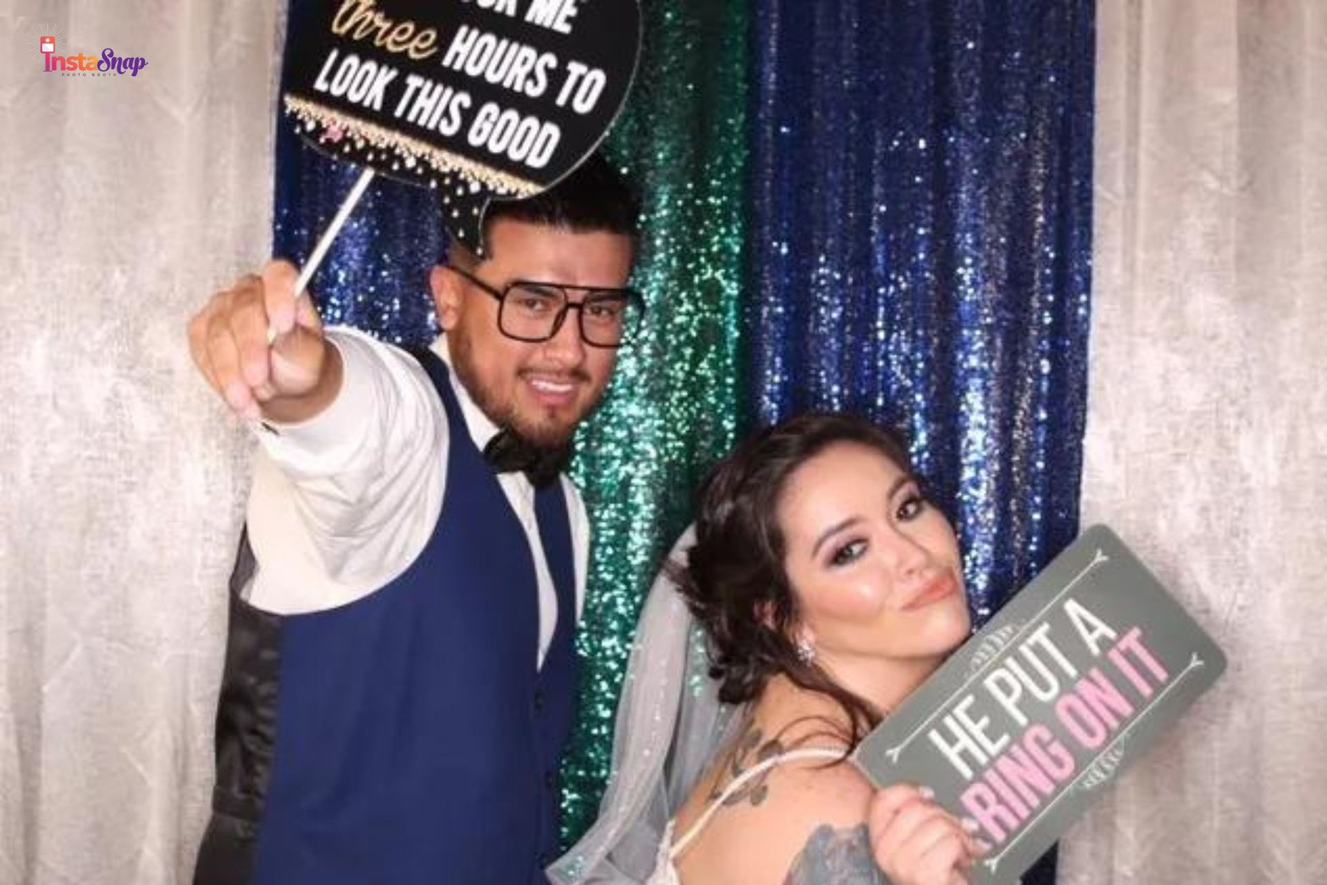 a couple who just got married posing at a photo booth rental for their wedding in Dallas-Fort Worth