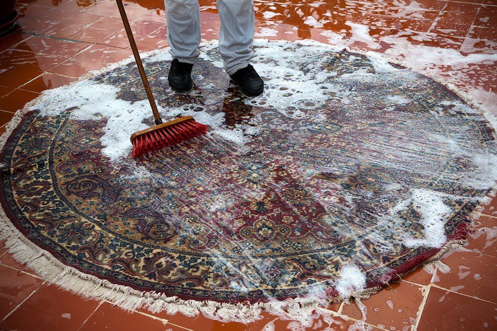 Man Washing a Rugs on the Tile Floor | Auburndale, FL | Wrights Floor & Rug Cleaners