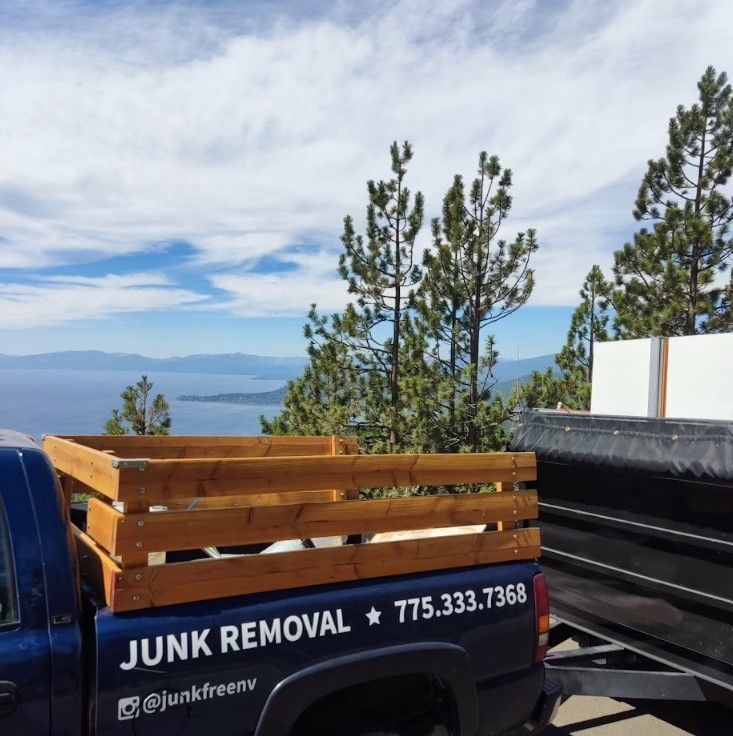 A junk removal truck with a wooden crate in the back